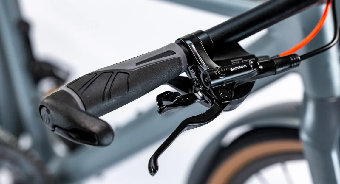 Dettaglio della manopola di una bicicletta, con grip ergonomico e design antiscivolo per una presa sicura durante la guida