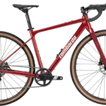 Vista laterale della bicicletta Lombardo Maranello, evidenziando il telaio grigio elegante, le ruote con copertoni marroni e i componenti di alta qualità, progettata per il gravel riding.